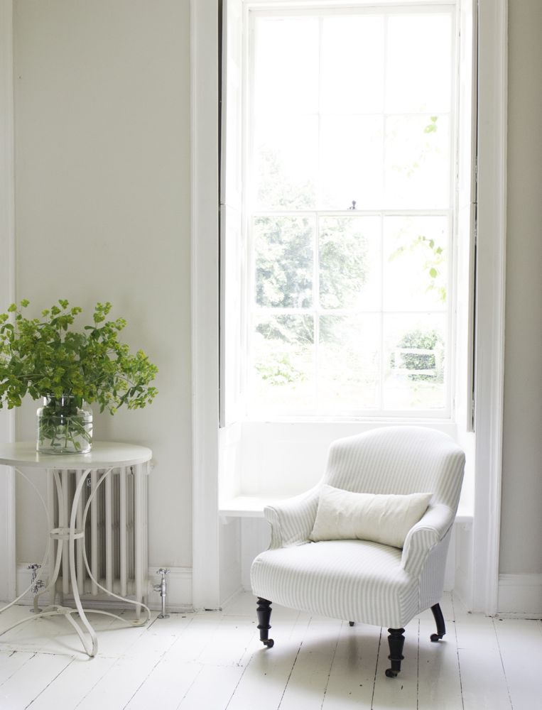 Multiple shades of white mix for a glorious cloud-like interior. Scandinavian style white Nordic French design details as well as spare decor style meet English countryside charm in "The Hatch," a photographic location in Wiltshire. Design: Atlanta Bartlett & Dave Coote of the Beach Studios. #livingroom #scandinavian #interiordesign #whitedecor #frenchnordic #nordicFrench #Swedishstyle #serene #shabbychic