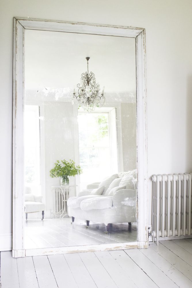 Multiple shades of white mix for glorious cloud-like Country French Nordic White Interiors. Scandinavian style white Nordic French design details as well as spare decor style meet English countryside charm in "The Hatch," a photographic location in Wiltshire. Design: Atlanta Bartlett & Dave Coote of the Beach Studios. #livingroom #scandinavian #interiordesign #whitedecor #frenchnordic #nordicFrench #Swedishstyle #serene #shabbychic