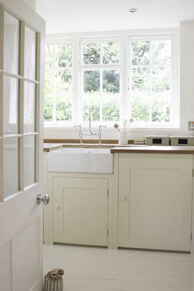 Multiple shades of white mix for glorious cloud-like Country French Nordic White Interiors. Scandinavian style white Nordic French design details as well as spare decor style meet English countryside charm in "The Hatch," a photographic location in Wiltshire. Design: Atlanta Bartlett & Dave Coote of the Beach Studios. #livingroom #scandinavian #interiordesign #whitedecor #frenchnordic #nordicFrench #Swedishstyle #serene #shabbychic