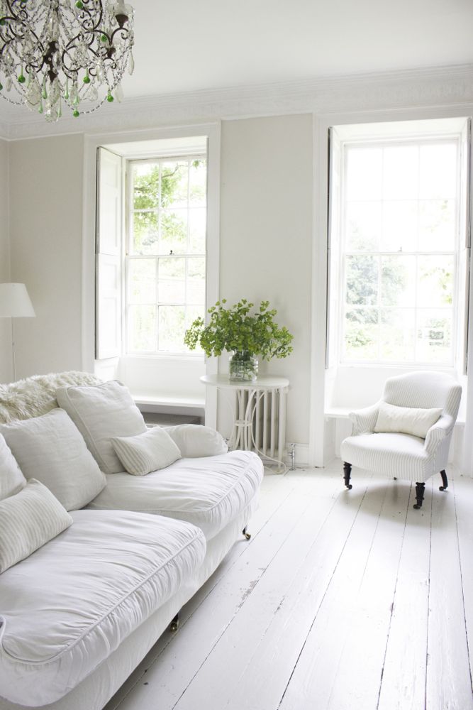 Multiple shades of white mix for glorious cloud-like Country French Nordic White Interiors. Scandinavian style white Nordic French design details as well as spare decor style meet English countryside charm in "The Hatch," a photographic location in Wiltshire. Design: Atlanta Bartlett & Dave Coote of the Beach Studios. #livingroom #scandinavian #interiordesign #whitedecor #frenchnordic #nordicFrench #Swedishstyle #serene #shabbychic