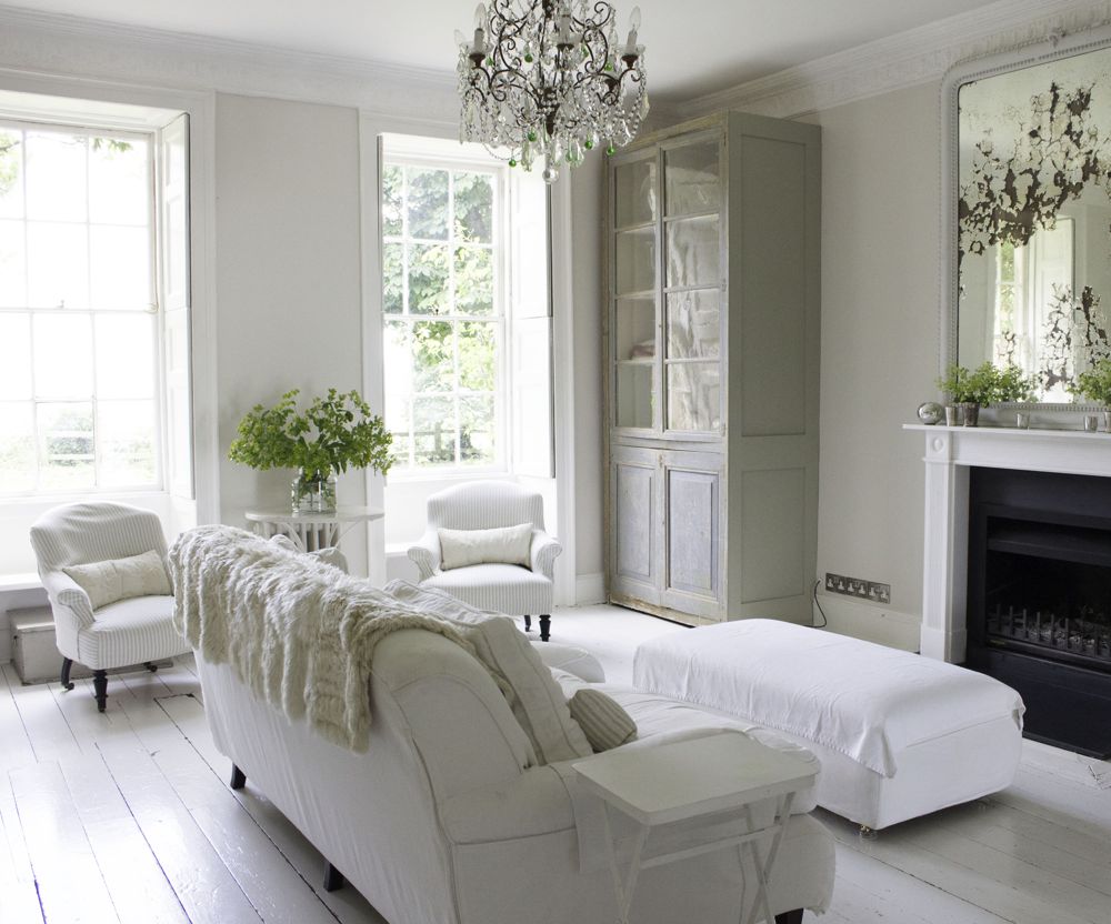 Multiple shades of white mix for glorious cloud-like Country French Nordic White Interiors. Scandinavian style white Nordic French design details as well as spare decor style meet English countryside charm in "The Hatch," a photographic location in Wiltshire. Design: Atlanta Bartlett & Dave Coote of the Beach Studios. #livingroom #scandinavian #interiordesign #whitedecor #frenchnordic #nordicFrench #Swedishstyle #serene #shabbychic