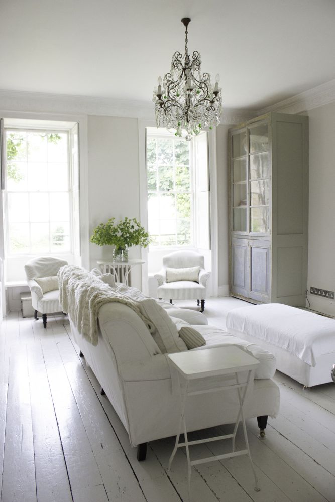 Multiple shades of white mix for a glorious cloud-like interior. Scandinavian style white Nordic French design details as well as spare decor style meet English countryside charm in "The Hatch," a photographic location in Wiltshire. Design: Atlanta Bartlett & Dave Coote of the Beach Studios. #livingroom #scandinavian #interiordesign #whitedecor #frenchnordic #nordicFrench #Swedishstyle #serene #shabbychic