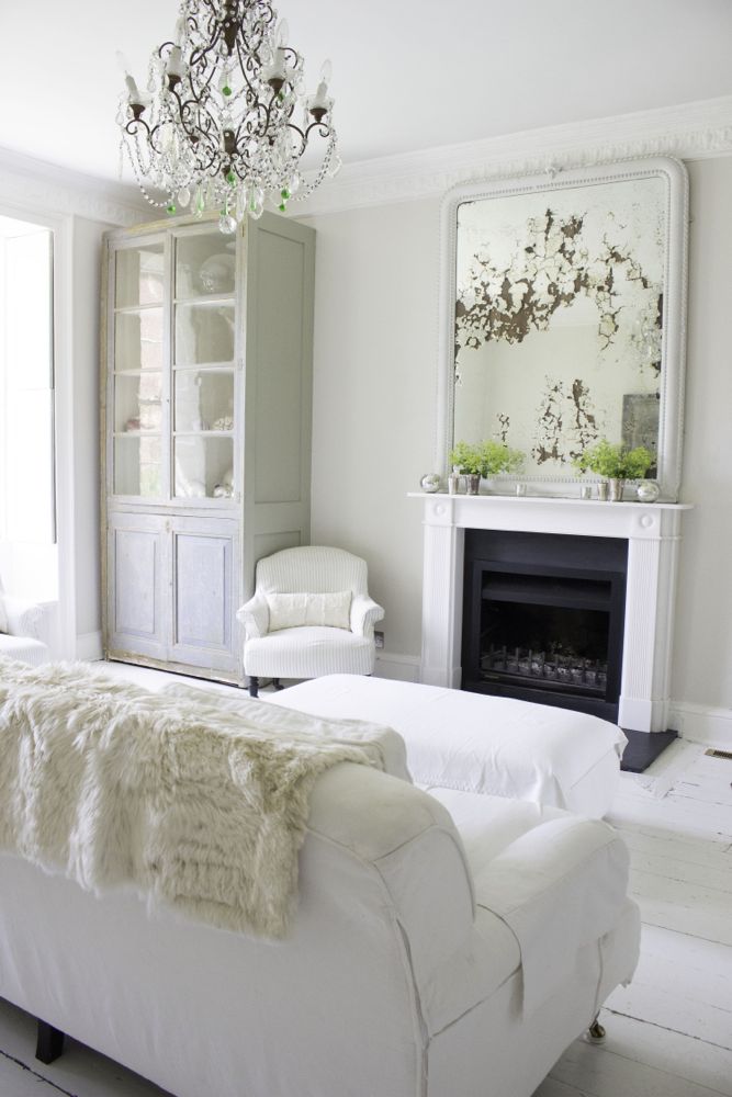 Multiple shades of white mix for glorious cloud-like Country French Nordic White Interiors. Scandinavian style white Nordic French design details as well as spare decor style meet English countryside charm in "The Hatch," a photographic location in Wiltshire. Design: Atlanta Bartlett & Dave Coote of the Beach Studios. #livingroom #scandinavian #interiordesign #whitedecor #frenchnordic #nordicFrench #Swedishstyle #serene #shabbychic