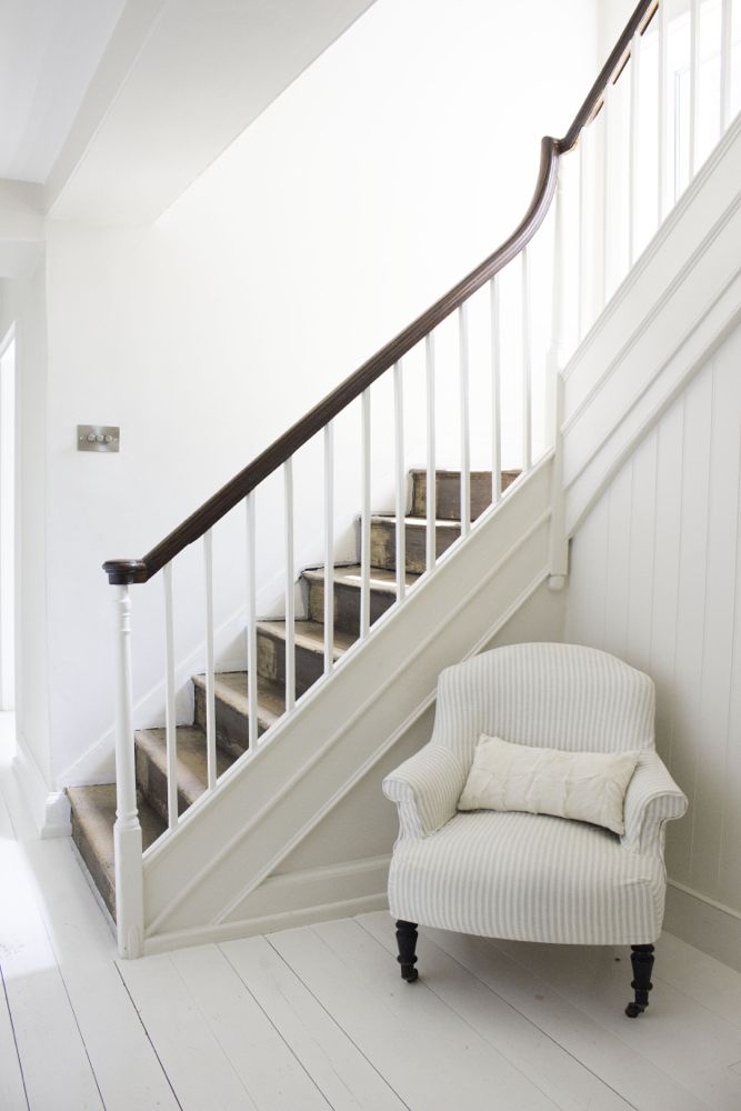 Multiple shades of white mix for glorious cloud-like Country French Nordic White Interiors. Scandinavian style white Nordic French design details as well as spare decor style meet English countryside charm in "The Hatch," a photographic location in Wiltshire. Design: Atlanta Bartlett & Dave Coote of the Beach Studios. #livingroom #scandinavian #interiordesign #whitedecor #frenchnordic #nordicFrench #Swedishstyle #serene #shabbychic