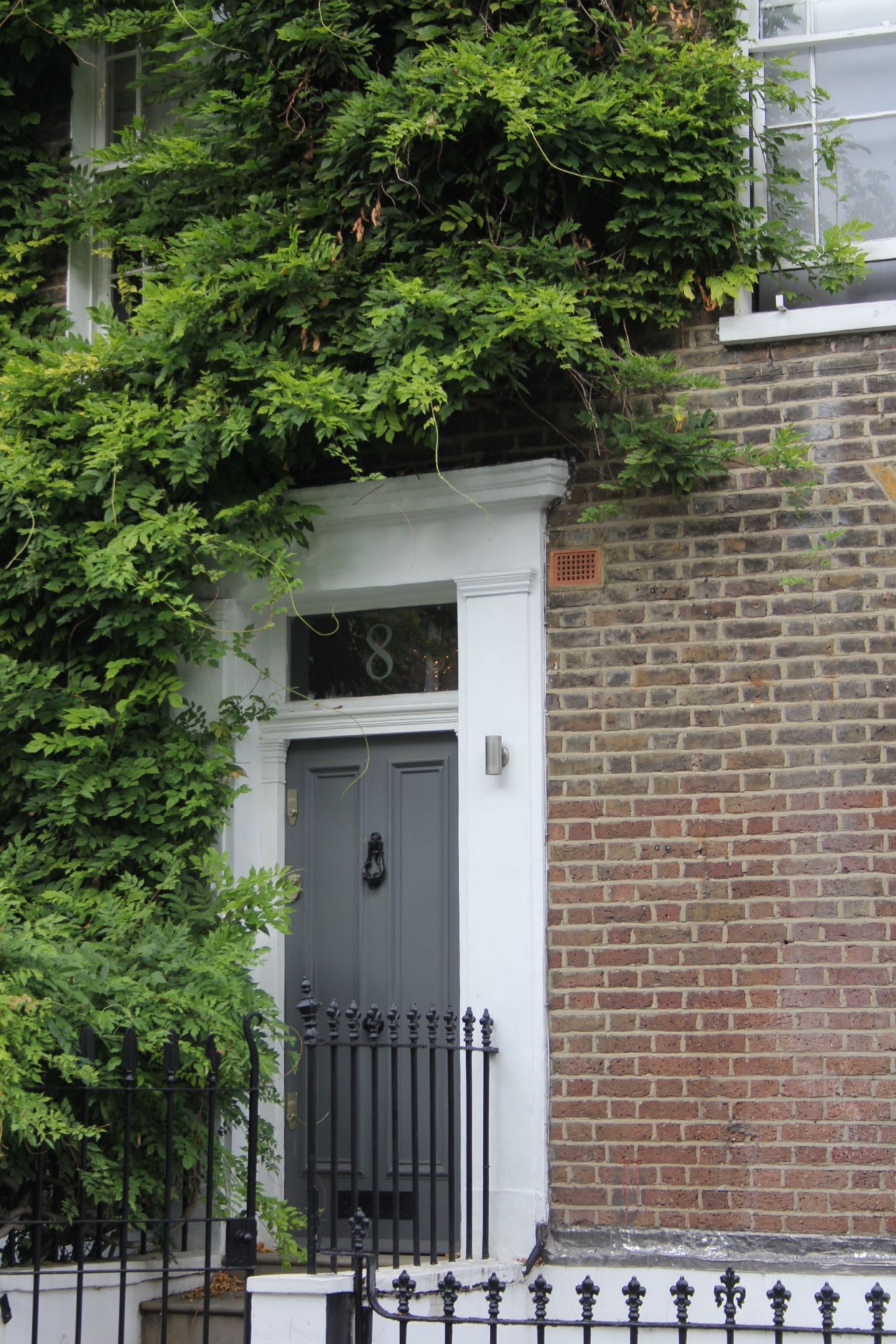 Charming grey door on row house. Hello Lovely Studio. Come tour these gorgeous front doors in Notting Hill and Holland Park...certainly lovely indeed. Curb appeal and Paint Color Inspiration. Lovely London Doors & Paint Color Ideas!