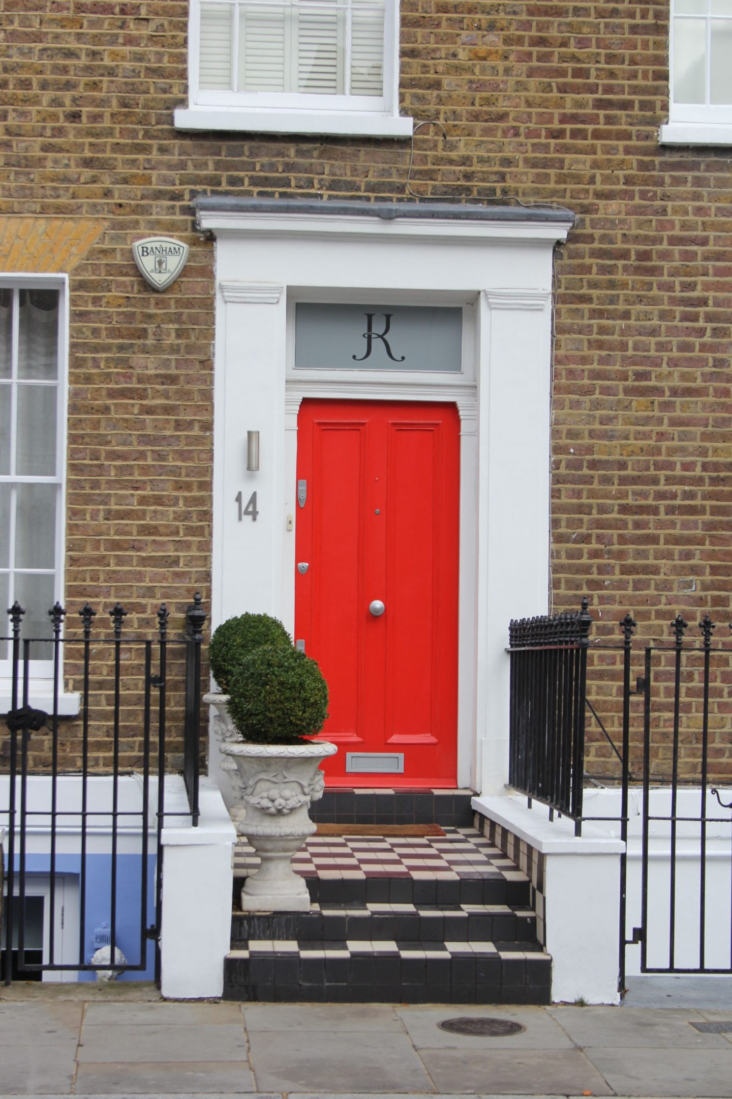 Shocking red orange on a front door! Hello Lovely Studio. Come tour these gorgeous front doors in Notting Hill and Holland Park...certainly lovely indeed. Curb appeal and Paint Color Inspiration. Lovely London Doors & Paint Color Ideas!