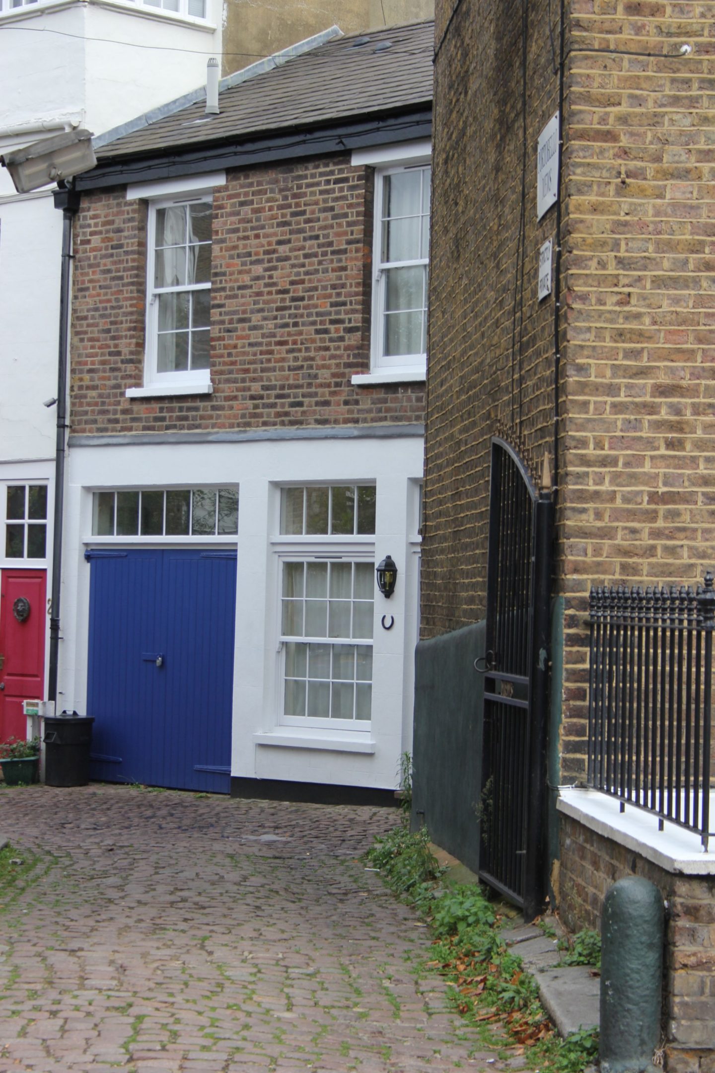 Bright electric blue painted stable doors to entrance of mews. Hello Lovely Studio. Come tour these gorgeous front doors in Notting Hill and Holland Park...certainly lovely indeed. Curb appeal and Paint Color Inspiration. Lovely London Doors & Paint Color Ideas!