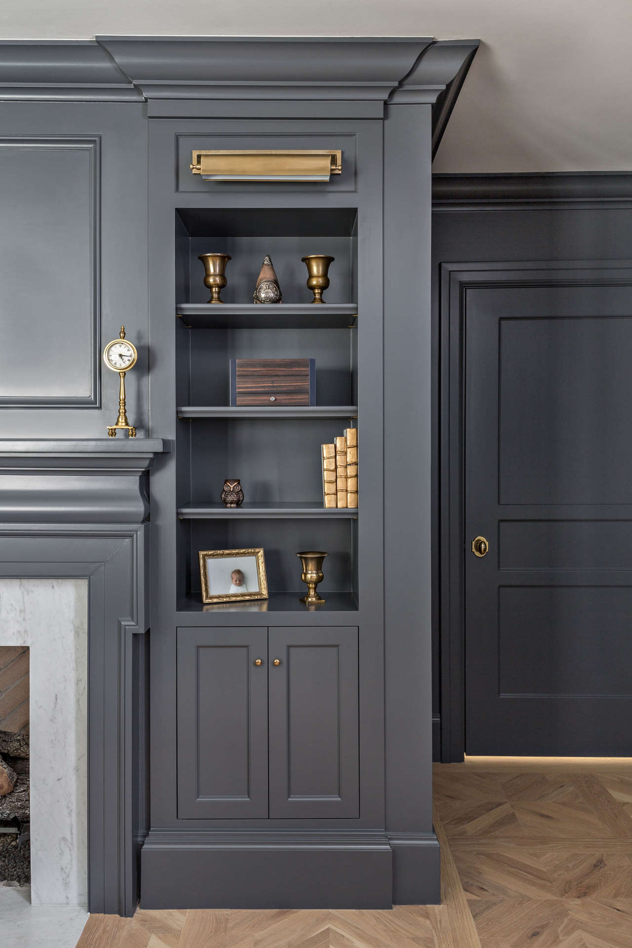 Dark gray painted built in cabinets flank a fireplace (try BM Cheating Heart for this look). Explore paint colors & timeless decorating. #thefoxgroup #custombuiltins #benjaminmoorecheatingheart