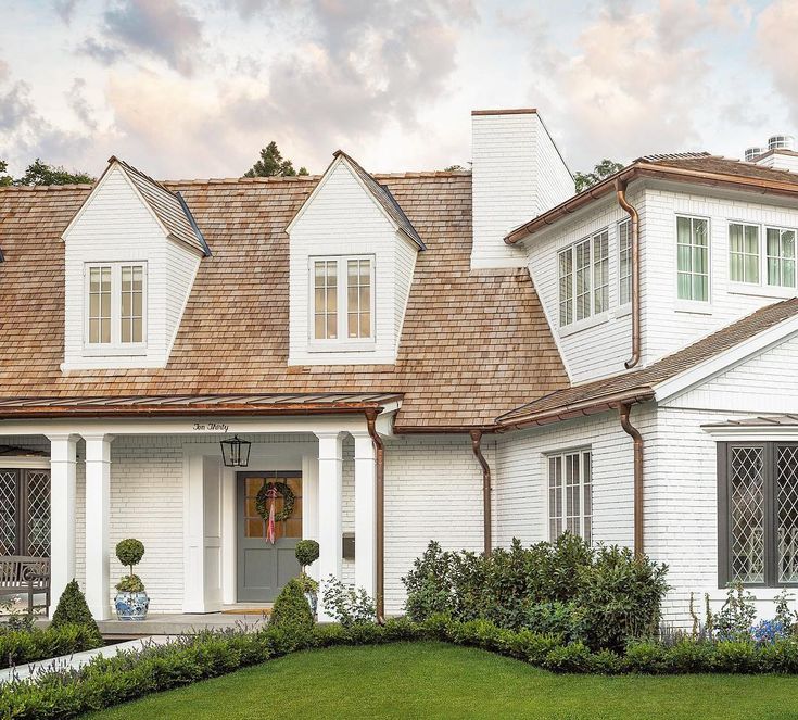 BM Galveston Gray front door with white brick (Simply White) on a renovated Tudor from the Fox Group. Come explore more paint colors and timeless decorating. #facadelovers #moderntudor #simplywhite