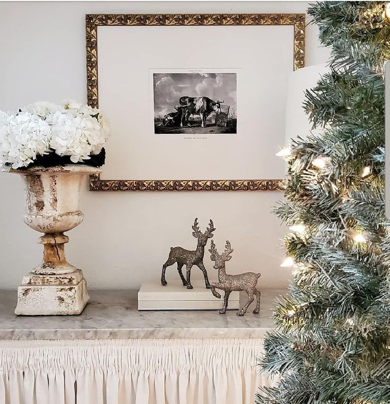 Holiday decor with a French country theme, Christmas tree, and old urn - The French Nest Interior Design Co. #holidaydecor #christmasdecorating #frenchcountry