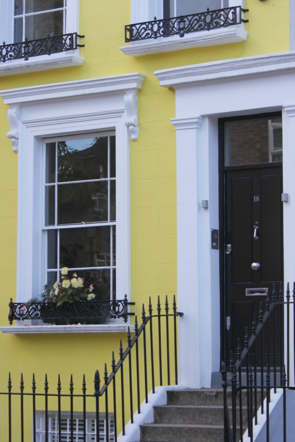 Bright yellow townhouse exterior in London. Hello Lovely Studio. Come tour these gorgeous front doors in Notting Hill and Holland Park...certainly lovely indeed. Curb appeal and Paint Color Inspiration. Lovely London Doors & Paint Color Ideas!