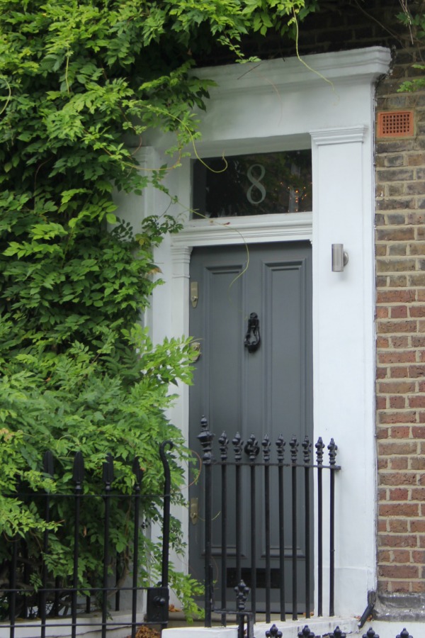 Charming grey painted front door on row house. Hello Lovely Studio. Come tour these gorgeous front doors in Notting Hill and Holland Park...certainly lovely indeed. Curb appeal and Paint Color Inspiration. Lovely London Doors & Paint Color Ideas!