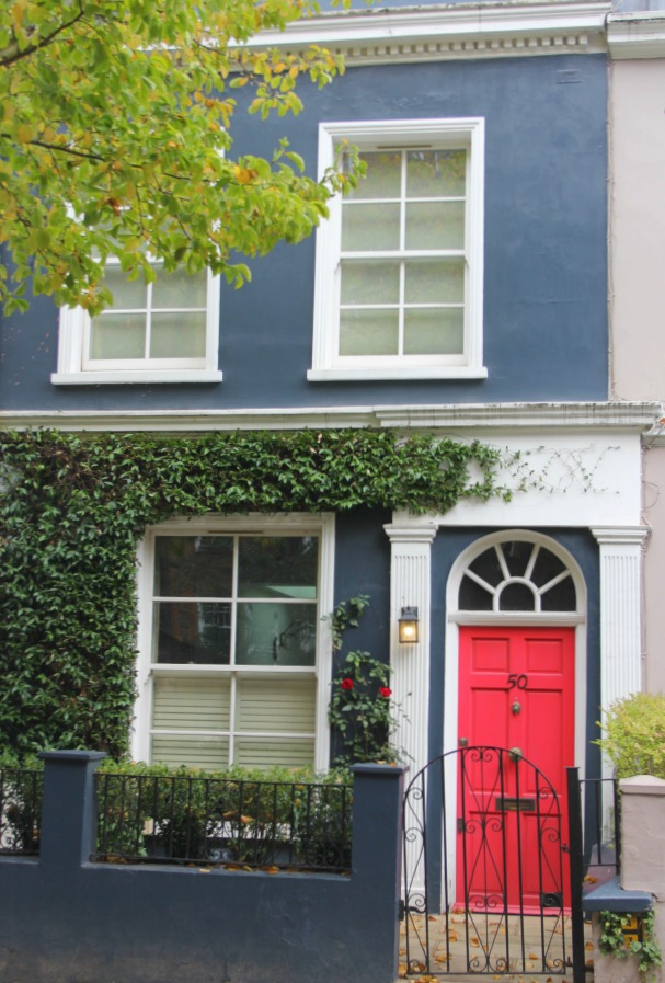 Medium denim blue painted stucco facade with bright red orange front door. Hello Lovely Studio. Come tour these gorgeous front doors in Notting Hill and Holland Park...certainly lovely indeed. Curb appeal and Paint Color Inspiration. Lovely London Doors & Paint Color Ideas!