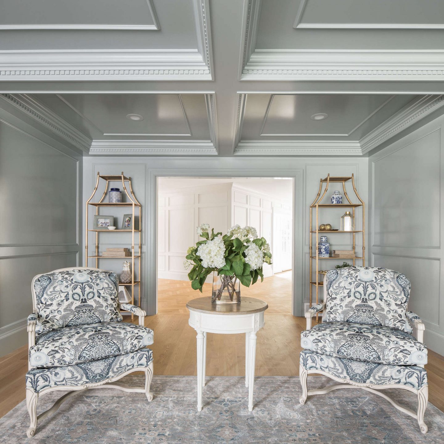 Bergere chairs in a paneled traditional style living area by the Fox Group. Come explore these timeless design ideas...hello lovely indeed. #interiordesign #thefoxgroup #millwork