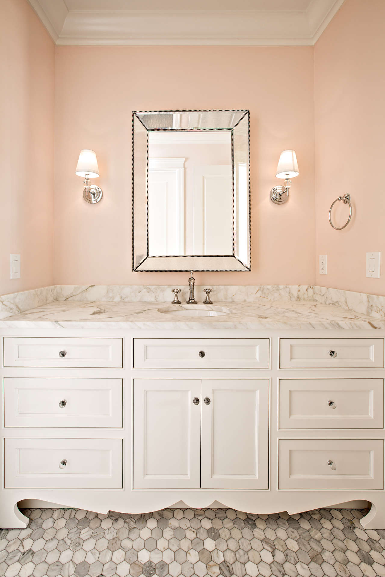 Blush pink walls in a beautiful powder room by The Fox Group.