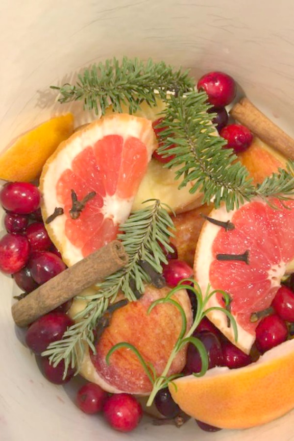 Christmas potpourri simmering on the stovetop. Grapefruit, rosemary, cranberries, cinnamon, and allspice! Hello Lovely Studio. #christmas #aroma #potpourri #simmering