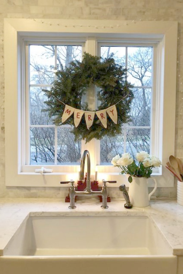 Fresh Christmas wreath over farm sink - Hello Lovely Studio.