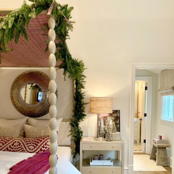 Bedroom with canopy bed draped in fresh greenery in a designer showhouse in Atlanta. #christmasdecor #interiordesign #bedroom