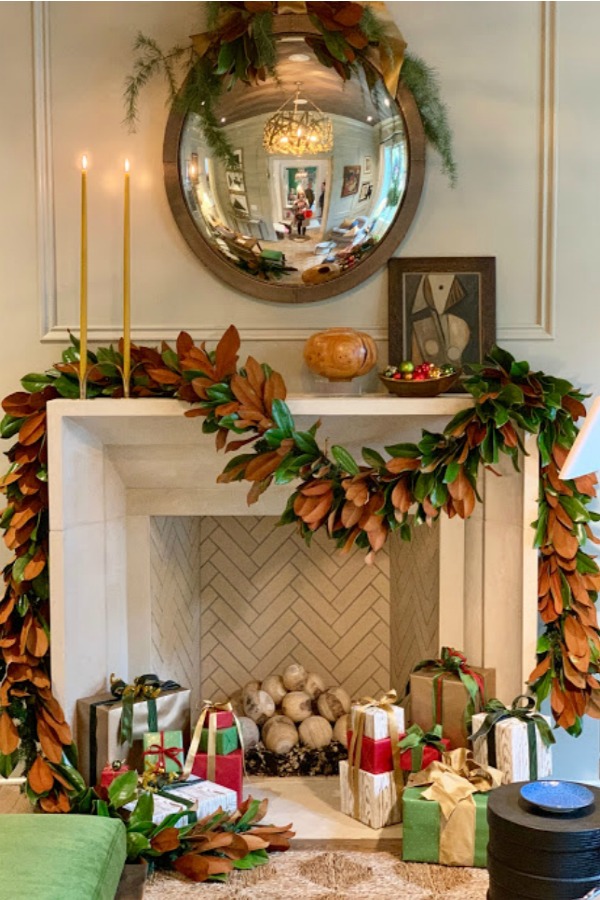 Elegant and sophisticated Christmas decor including a stone fireplace adorned with a magnificent fresh garland. Beautiful holiday decor inspiration from interior designers and bloggers. Come discover 28 Amazing Christmas Decorating Ideas! #christmasdecor #holidaydecorating