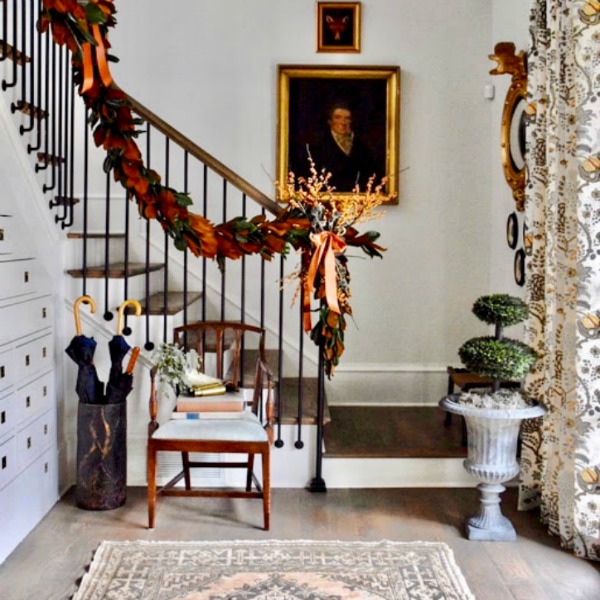 Beautiful staircase draped with neutral greenery for Christmas in a showhouse in Atlanta.