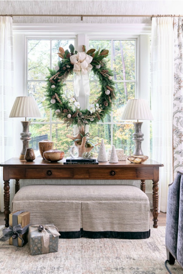 Elegant Christmas wreath and decor in a vignette at a showhouse in Atlanta. Beautiful holiday decor inspiration from interior designers and bloggers. Come discover 28 Amazing Christmas Decorating Ideas! #christmasdecor #holidaydecorating