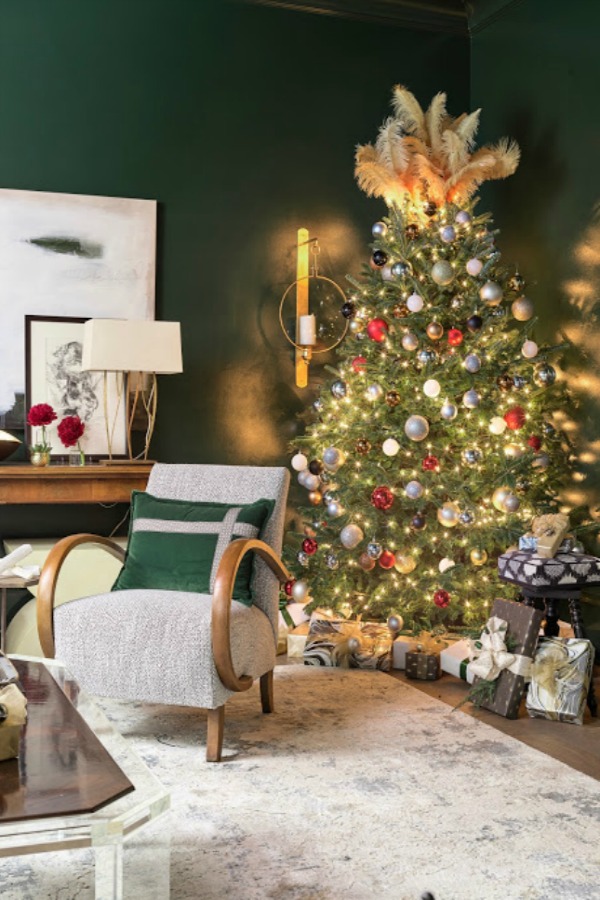 Christmas tree topped with feathers and adorned with colorful modern pops of color and sophistication in an Atlanta home for the holidays showhouse. Beautiful holiday decor inspiration from interior designers and bloggers. Come discover 28 Amazing Christmas Decorating Ideas! #christmasdecor #holidaydecorating