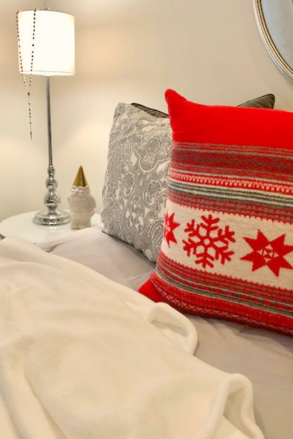 Bold red Scandi pillow in a bedroom. Hello Lovely Studio.