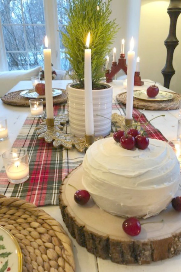 Tablescape with mini layer cake, cherries, and plaid for Christmas. Hello Lovely Studio.