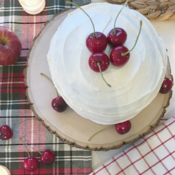 My mini layer cake with cherries on top - a farmhouse Christmas tablescape by Hello Lovely Studio.