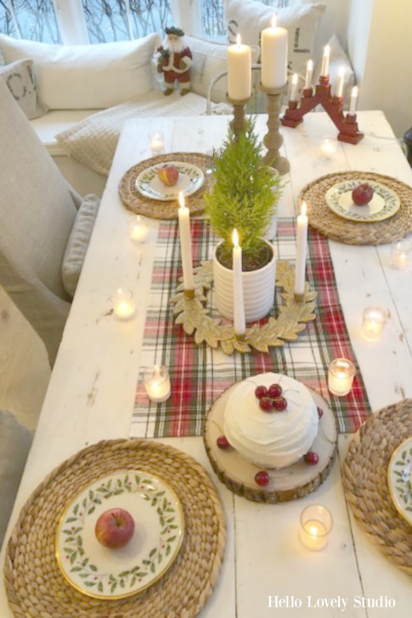 Scandinavian style and farmhouse touches at a breakfast table decorated simply with red accents for Christmas. Beautiful holiday decor inspiration from interior designers and bloggers. Come discover 28 Amazing Christmas Decorating Ideas! #christmasdecor #holidaydecorating