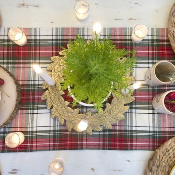 Farmhouse Christmas tablescape with red cherries, plaid, and holly Lenox plates. Hello Lovely Studio. Come find the mini cake recipe and sources for decor! #hellolovelystudio #tablescape #christmas #cherries #cake