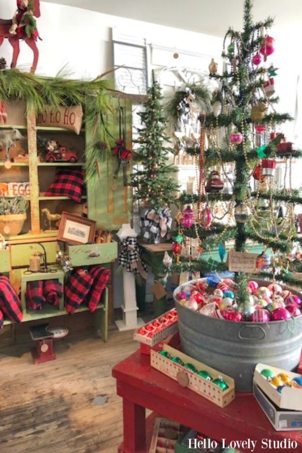 Vintage style Christmas decor with a tree in a galvanized tub and a gorgeous green primitive cabinet!