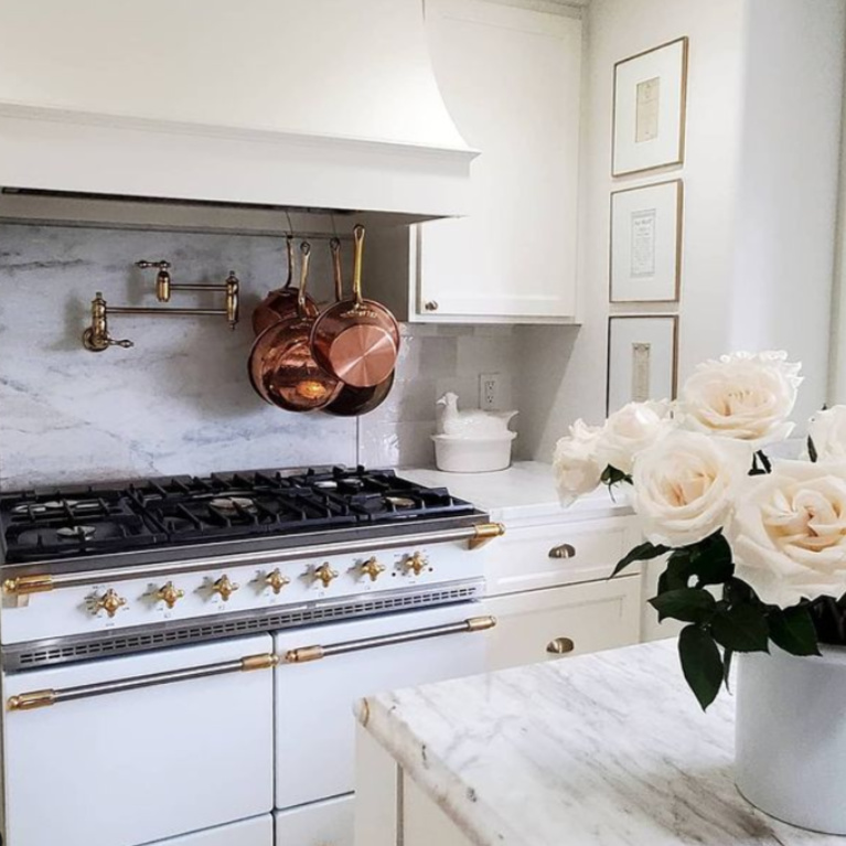 Glorious white French country kitchen with Lacanche range and copper pots - @thefrenchnestcointeriordesign. #frenchcountrykitchen #frenchkitchen #modernfrench