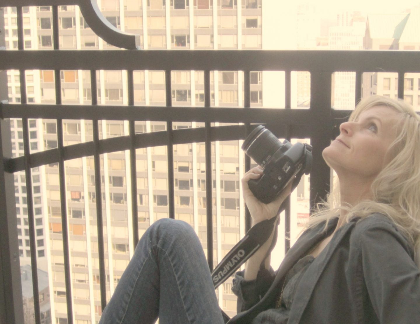 Michele of Hello Lovely Studio with camera on balcony of Waldorf Astoria Chicago. #hellolovelystudio