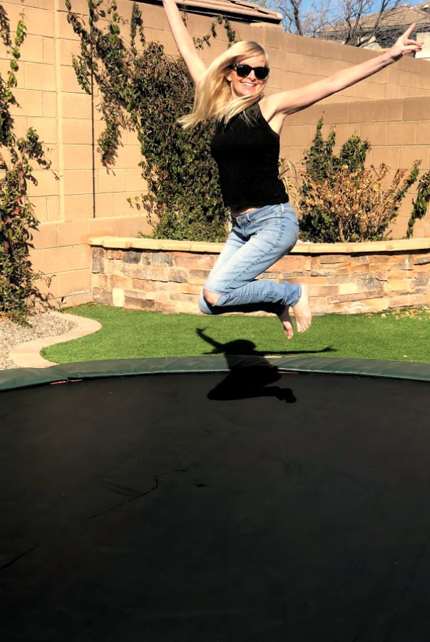 Michele of Hello Lovely Studio jumping on trampoline.