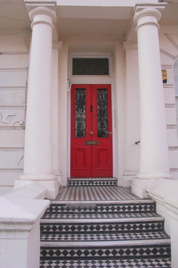 Vibrant red door in London. Notting Hill beauty, classic architecture, and inspiration from a London stroll by Hello Lovely Studio. Personal Reflections: What Does Greater Kindness to Yourself Look Like?