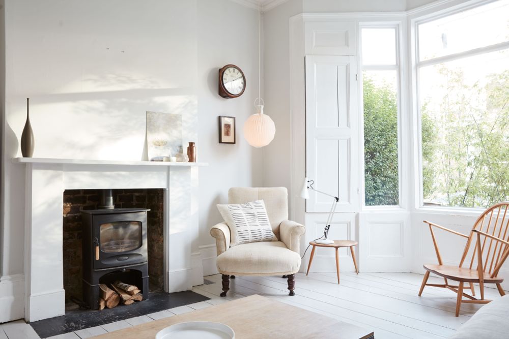 All white decor with simplicity, rustic design elements, and understated simplicity in a London Home offered by The Beach Studios. #whitedecor #housetour #simpledecor #interiordesign #vintagestyle #shabbychic