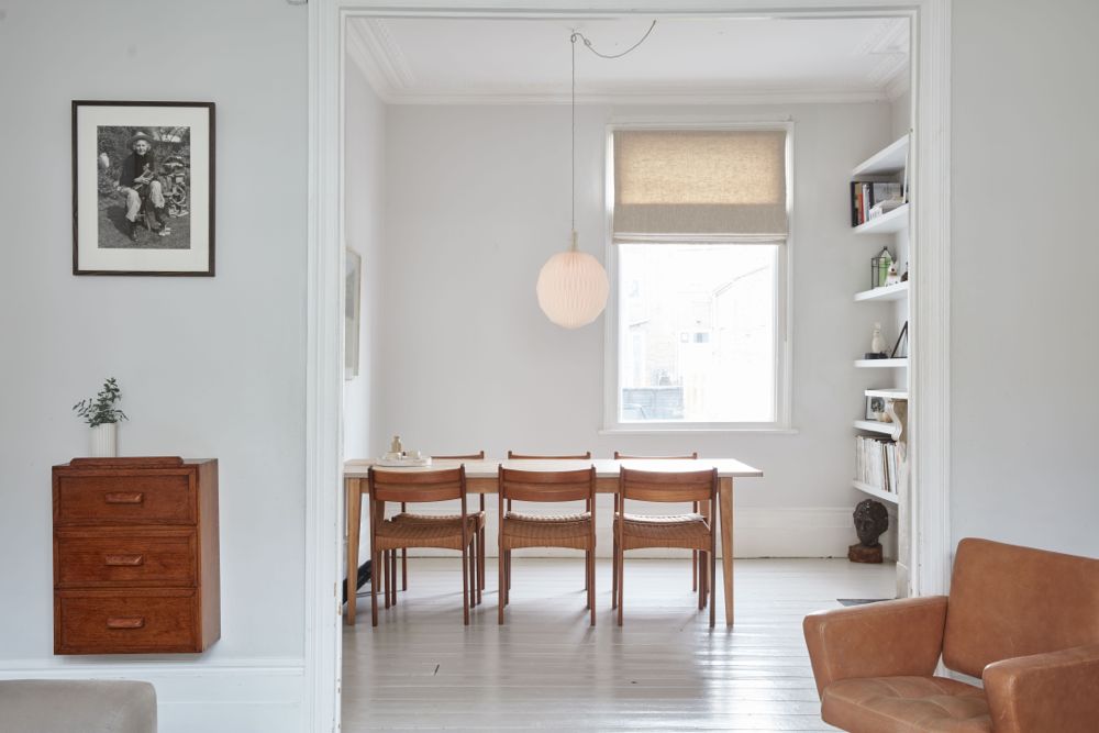 All white decor with simplicity, rustic design elements, and understated simplicity in a London Home offered by The Beach Studios. #whitedecor #housetour #simpledecor #interiordesign #vintagestyle #shabbychic