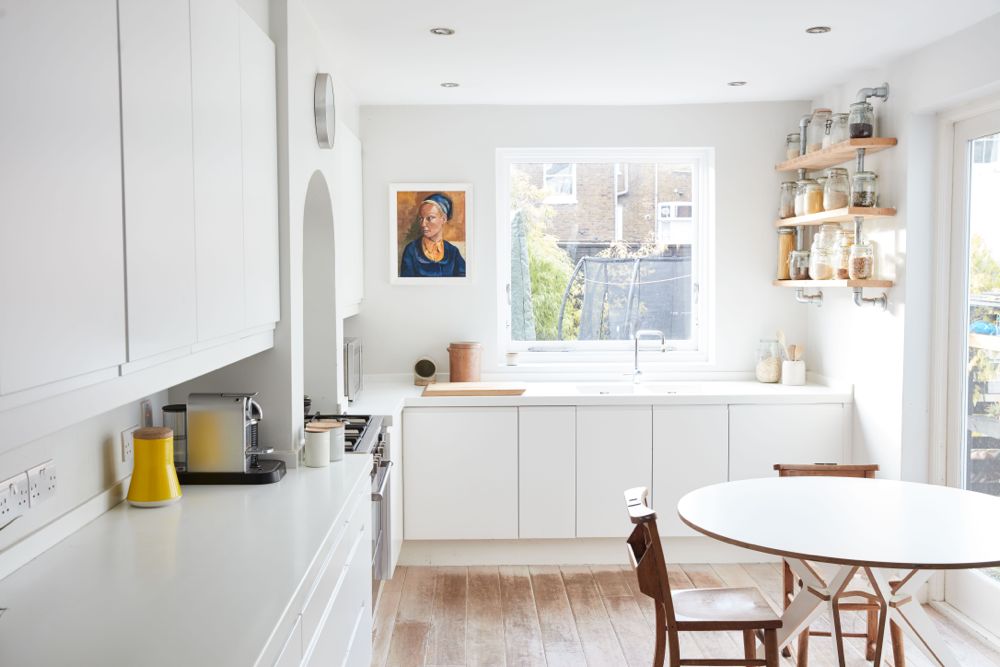 All white decor with simplicity, rustic design elements, and understated simplicity in a London Home offered by The Beach Studios. #whitedecor #housetour #simpledecor #interiordesign #vintagestyle #shabbychic