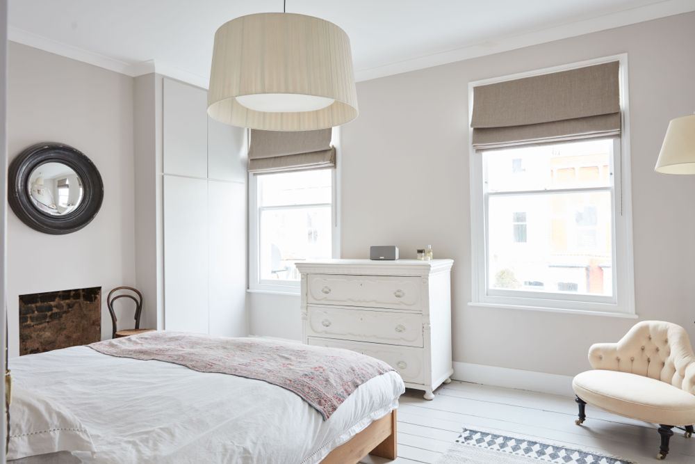 All white decor with simplicity, rustic design elements, and understated simplicity in a London Home offered by The Beach Studios. #whitedecor #housetour #simpledecor #interiordesign #vintagestyle #shabbychic