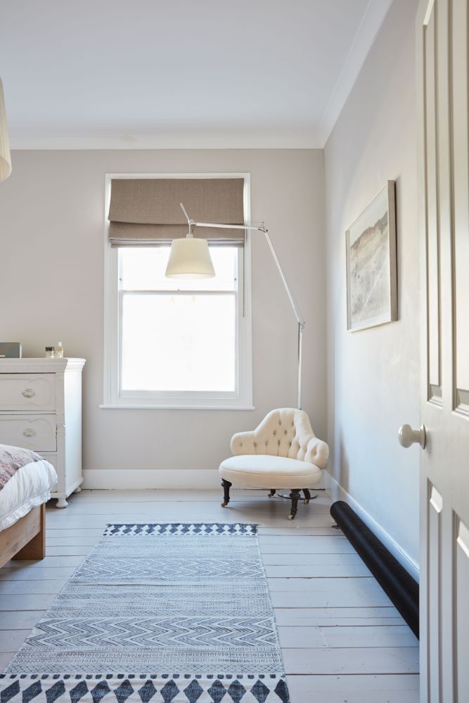 All white decor with simplicity, rustic design elements, and understated simplicity in a London Home offered by The Beach Studios. #whitedecor #housetour #simpledecor #interiordesign #vintagestyle #shabbychic