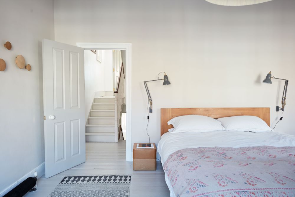 All white decor with simplicity, rustic design elements, and understated simplicity in a London Home offered by The Beach Studios. #whitedecor #housetour #simpledecor #interiordesign #vintagestyle #shabbychic