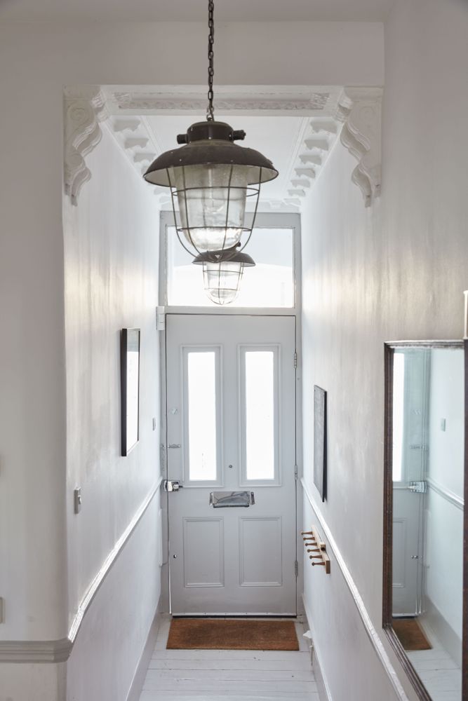 All white decor with simplicity, rustic design elements, and understated simplicity in a London Home offered by The Beach Studios. #whitedecor #housetour #simpledecor #interiordesign #vintagestyle #shabbychic