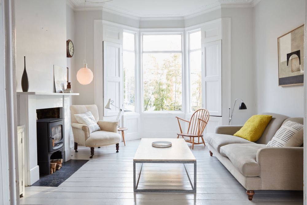 All white decor with simplicity, rustic design elements, and understated simplicity in a London Home offered by The Beach Studios. #whitedecor #housetour #simpledecor #interiordesign #vintagestyle #shabbychic