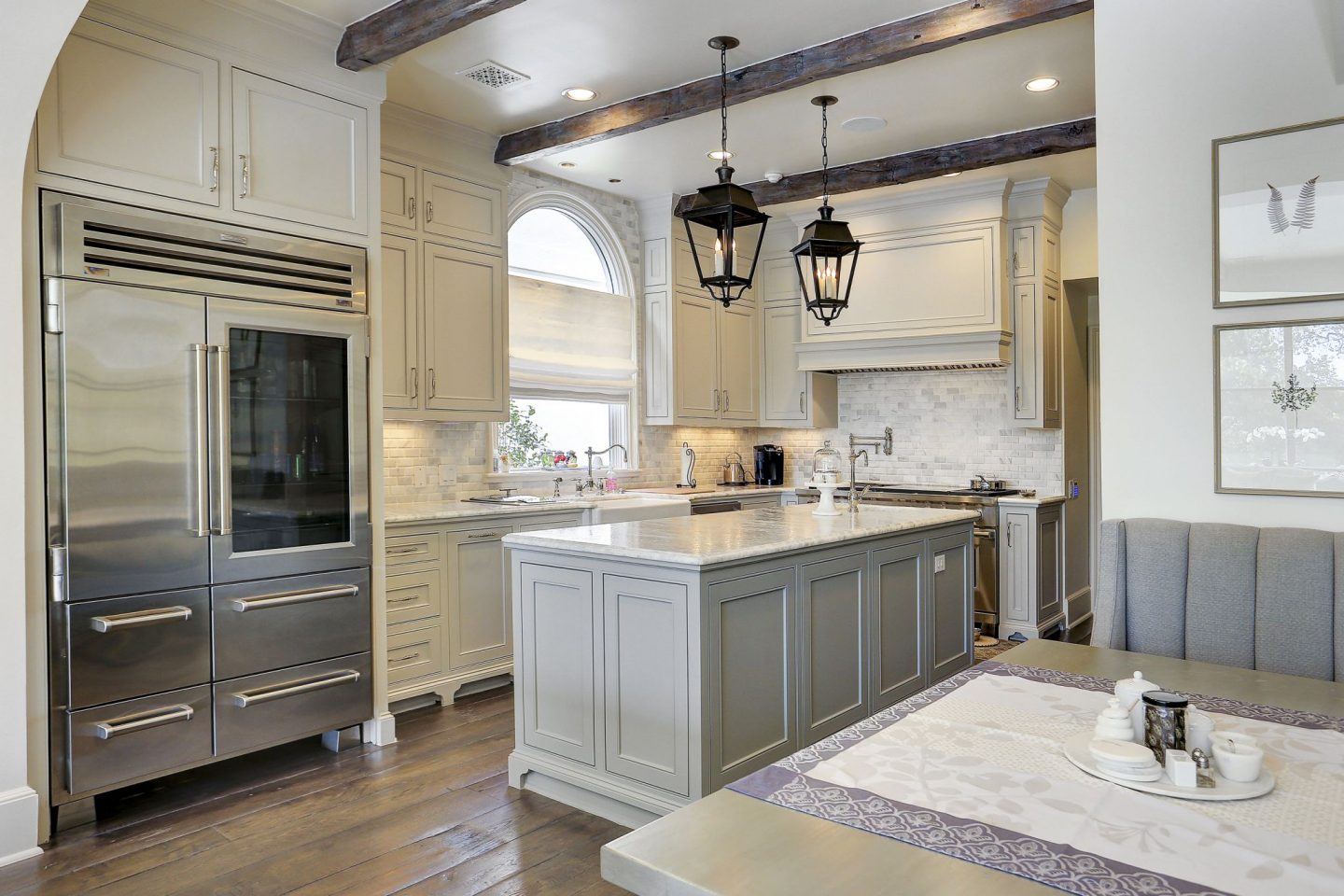 Grey and white French country kitchen in a Houston home by Thomas O'Neill. Come explore more Country French Decor Ideas from luxurious and grand homes.