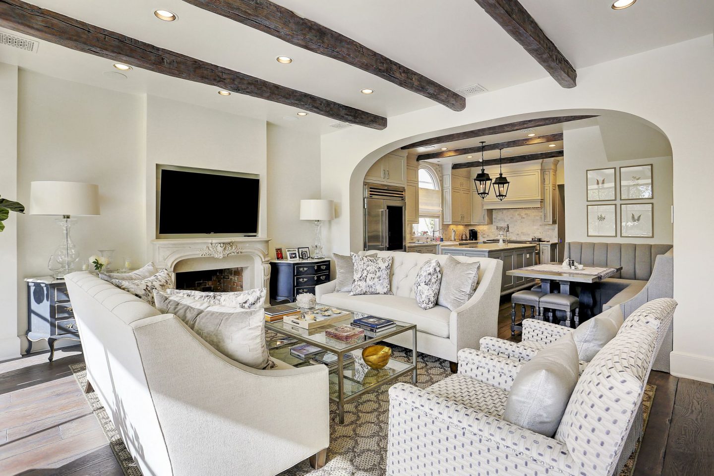 Exquisite white French country living room in a home by Thomas O'Neill Homes. Come explore more Country French Decor Ideas from luxurious and grand homes.