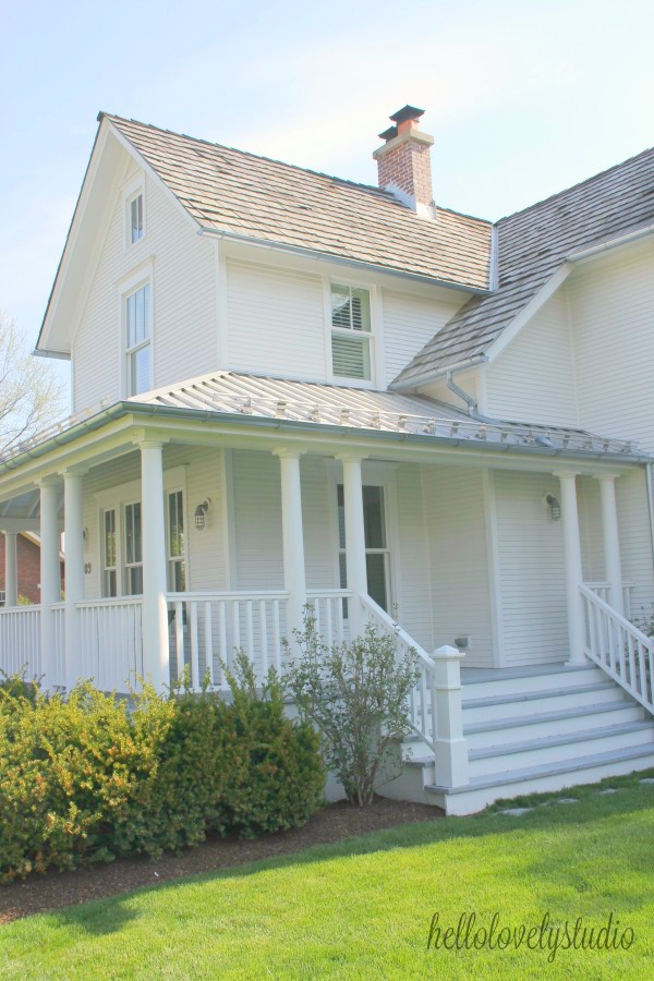 Beautiful white historic farmhouse exterior. Hello Lovely Studio. #farmhouse #houseexterior #wraparoundporch