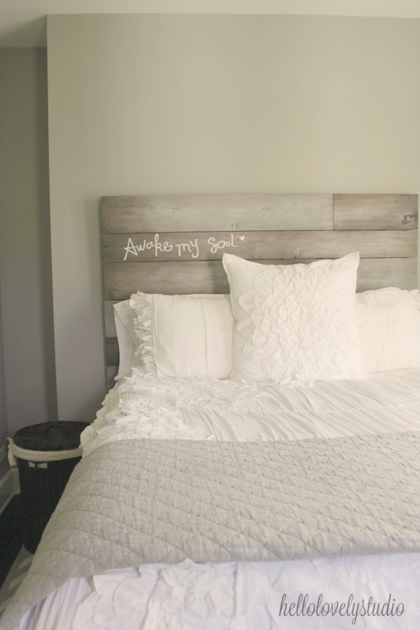 Beautiful handmade rustic plank headboard inscribed with AWAKE MY SOUL. A modern farmhouse bedroom with romantic white bedding. Hello Lovely Studio.