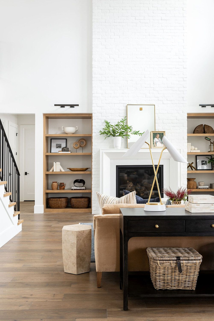 Modern rustic great room with white painted brick chimney, natural wood accents, and warm laid back style. #studiomcgee #livingroom #greatroom #beckhamproject #modernrustic