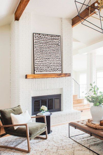 Black framed art on rustic wood mantel in a modern rustic living room designed by Scout & Nimble. #modernrustic #livingrooms #neutraldecor 